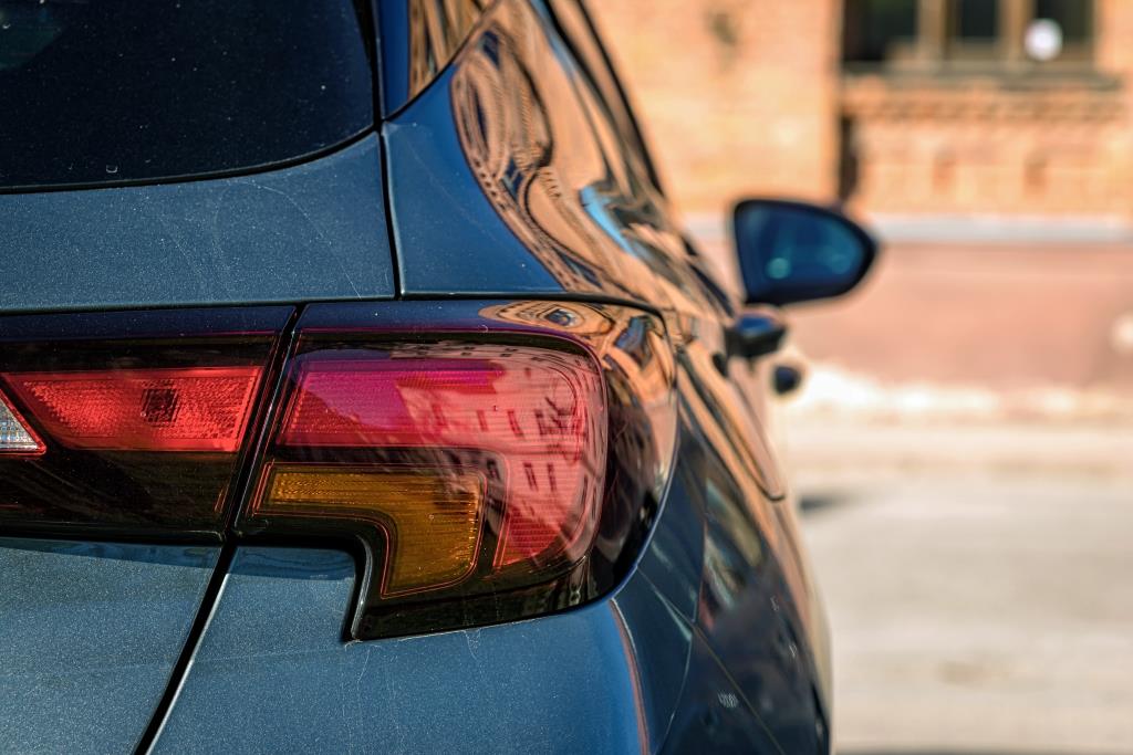 rear light of a parked car on the side of the street