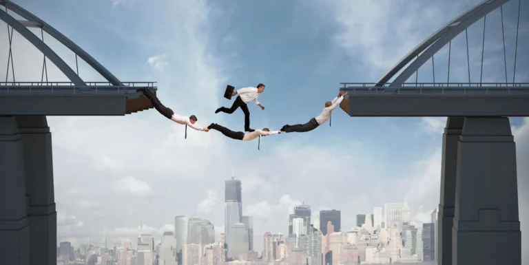 21139673 - teamwork concept with running businessman over the bridge