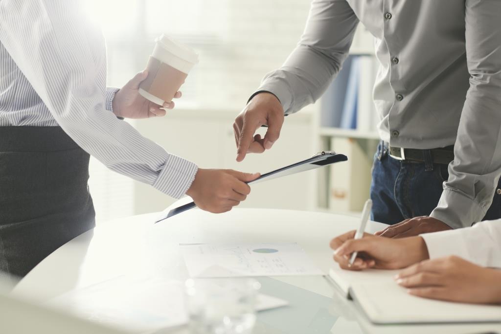 Cropped image of business colleagues working together in office