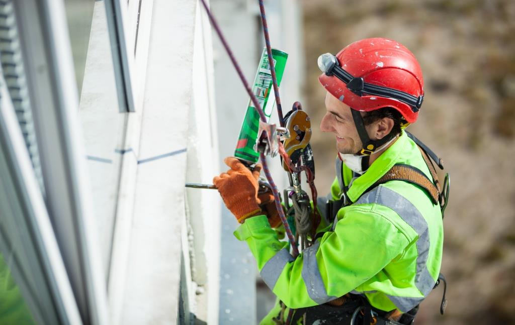 Cheerful industrial climber during winterization works