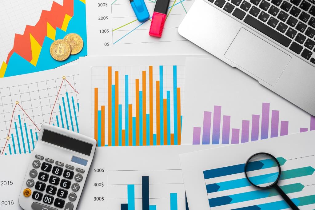 Business graphs paper and calculator on table